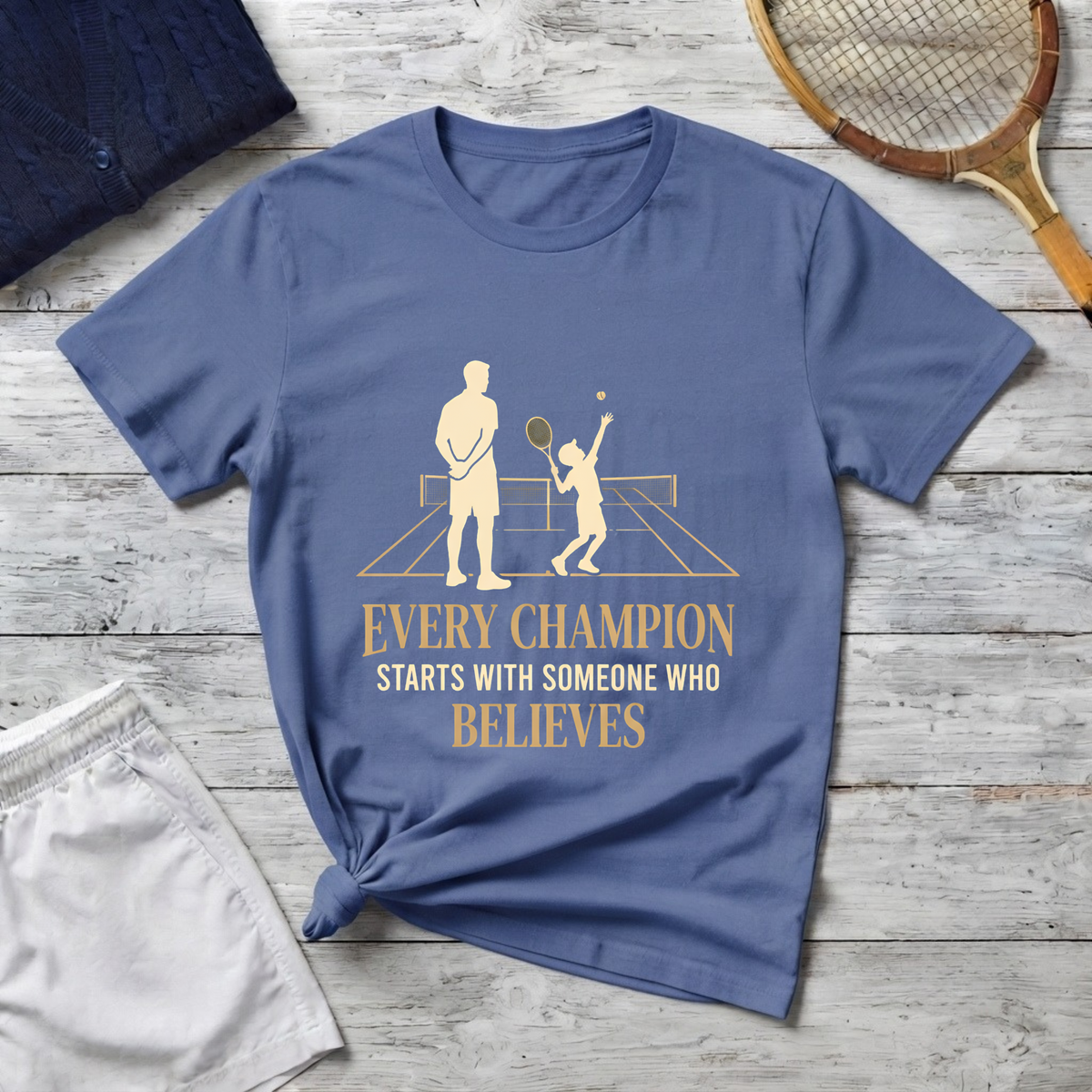 Tennis dad T‑Shirt — “Every Champion Starts With Someone Who Believes”